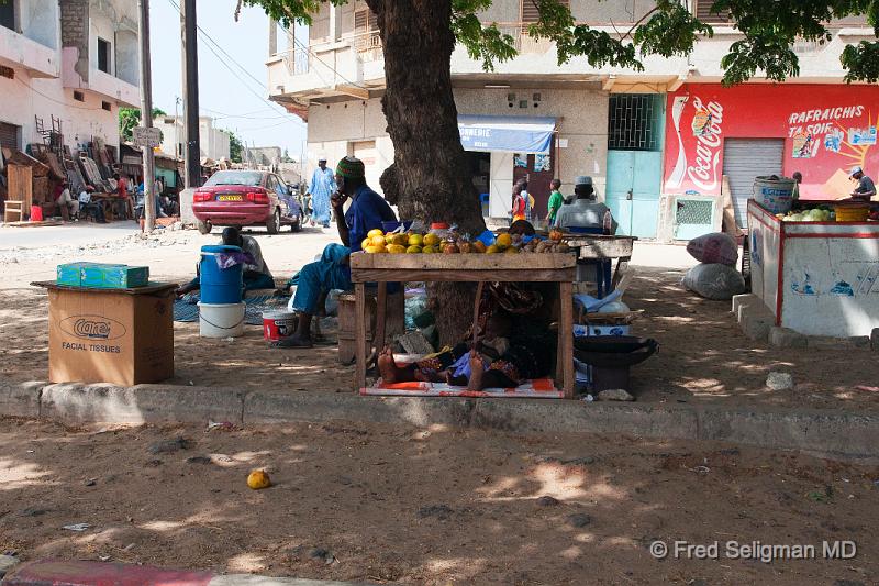 20090528_160402 D300 X1.jpg - Fruit stall, Dakar.  Note adult and youngster asleep underneath